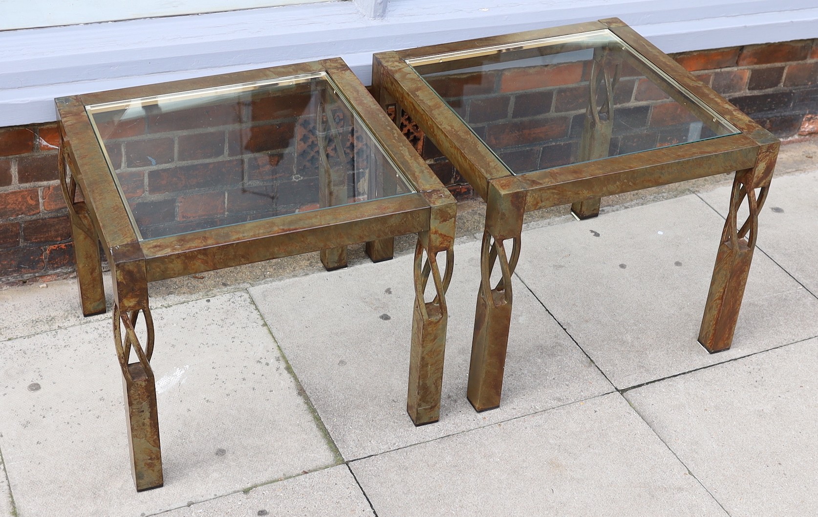 A pair of contemporary bronze metal and glass occasional tables, width 60cm. height 51cm